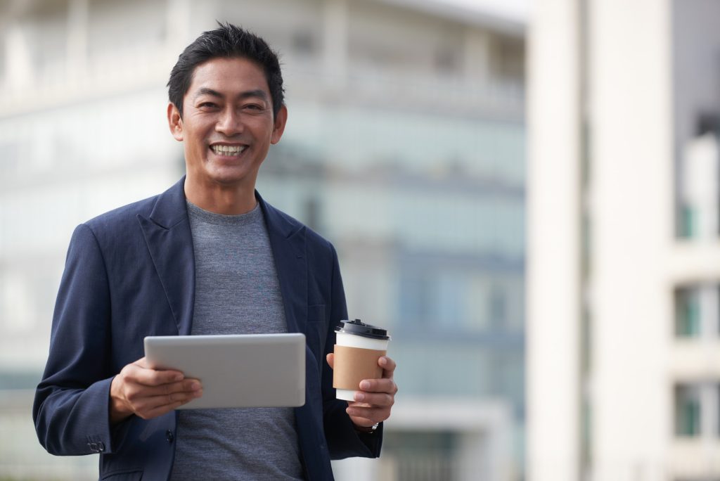 Happy Middle-aged Entrepreneur with Table