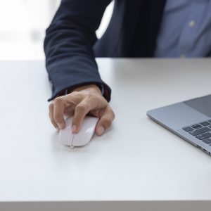 Image of Asian man hands clicking computer mouse