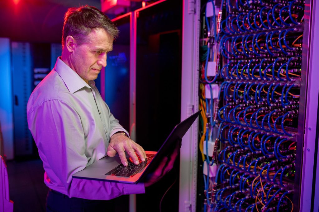 Mature IT engineer working with server