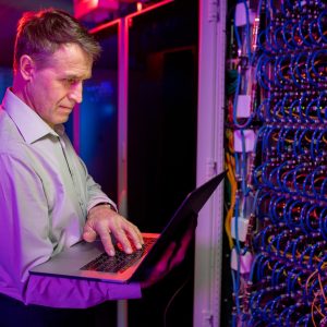 Mature IT engineer working with server