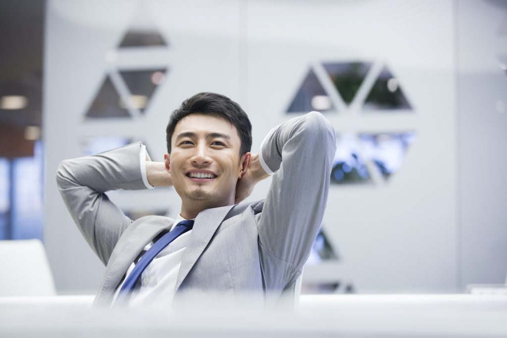 Young businessman thinking in office